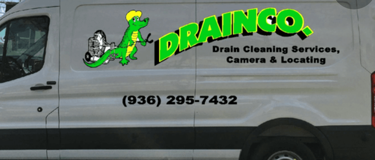 Close-up of the DrainCo van door decal with logo and phone number